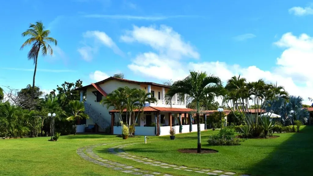 Bahia Vik — Bahia Vik is nestled within a sprawling 5000 square meter tropical garden, creating an immediate sense of calm and natural beauty. The proximity to the vibrant coastal city of Salvador da Bahia, yet being just 4 km from fantastic coconut palm beaches, offers a blend of accessibility and tranquil seclusion. The atmosphere is one of relaxed luxury, designed to facilitate a stress-free return to self.