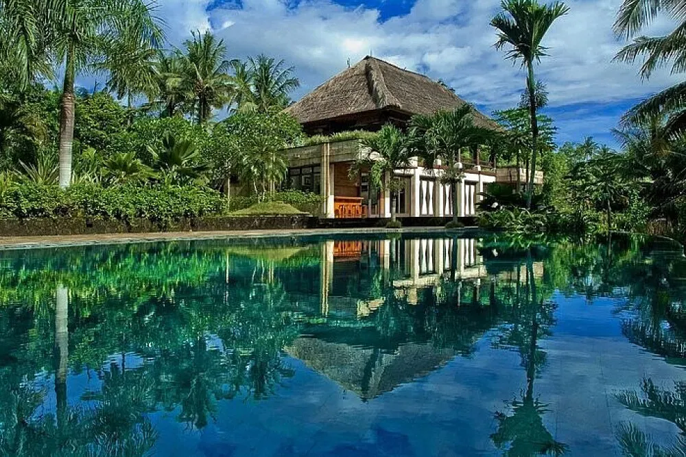 Bali Purnati Centre for the Arts — The center is situated near Ubud, Bali, amidst lush tropical gardens and terraced rice fields. The atmosphere is one of serene beauty, blending natural landscapes with traditional Balinese architectural elements.