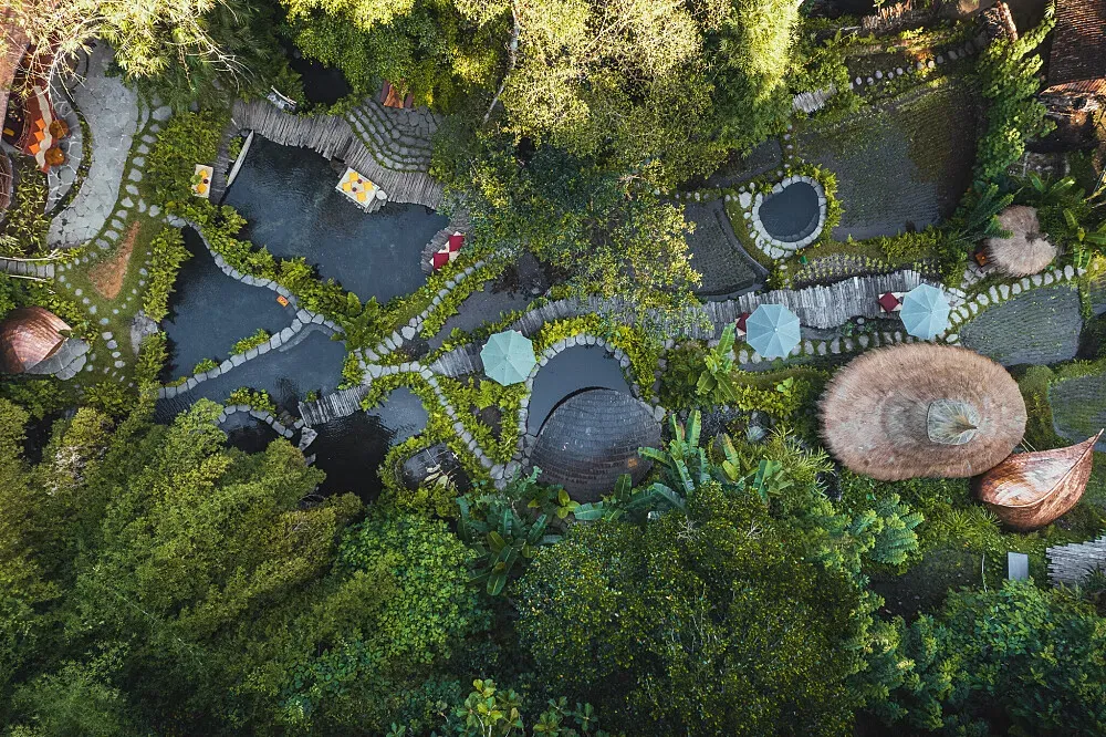 Bambu Indah Resort — This resort is located in a lush jungle environment in Ubud, Bali. The atmosphere is one of profound peace and harmony, designed to connect guests deeply with the surrounding natural beauty. It feels like a private, luxurious sanctuary within a vibrant ecosystem.