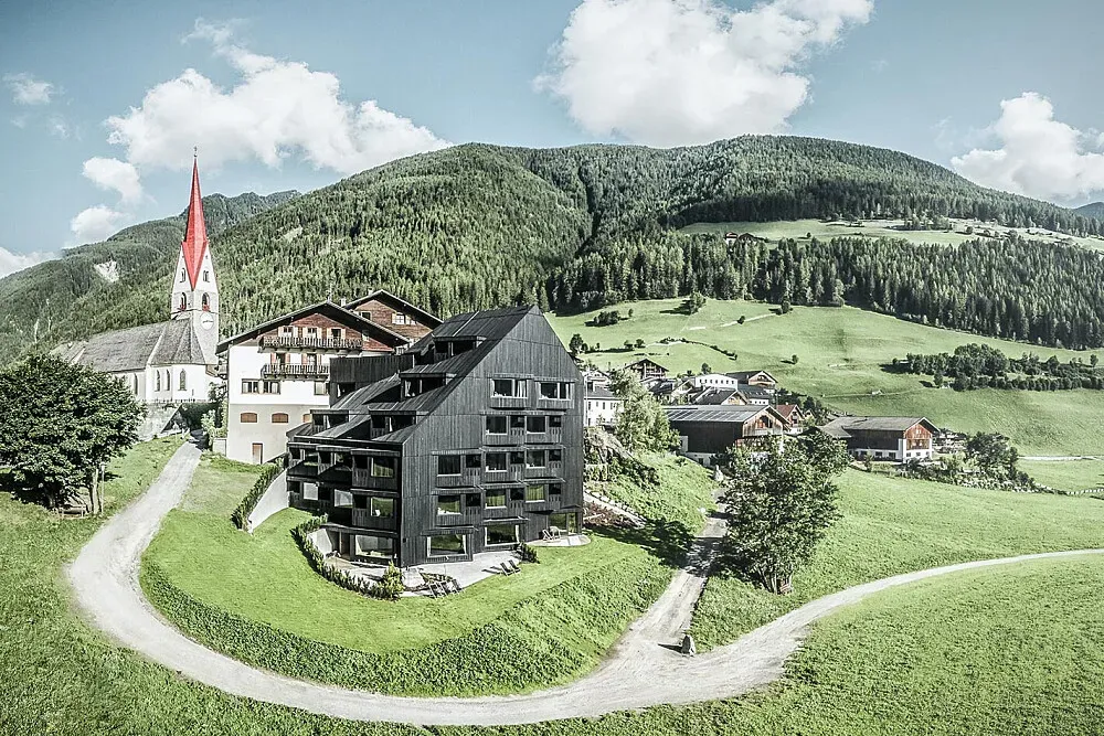 Biohotel Buehelwirt — The Biohotel Buehelwirt is situated in the Ahrntal region, surrounded by the majestic South Tyrolean mountains. This alpine environment provides a naturally calming and inspiring backdrop, ideal for those looking to escape urban noise and immerse themselves in pristine nature.