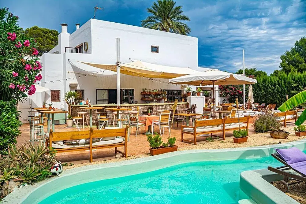 BOUTIQUE HOSTAL LA CURANDERA — set on the beautiful island of Ibiza, this hostal provides a serene backdrop for your retreat. The surroundings offer a blend of natural beauty and a peaceful atmosphere, allowing guests to disconnect from daily distractions and focus on their well-being. It's a chance to experience the quieter side of Ibiza, away from the bustling crowds.