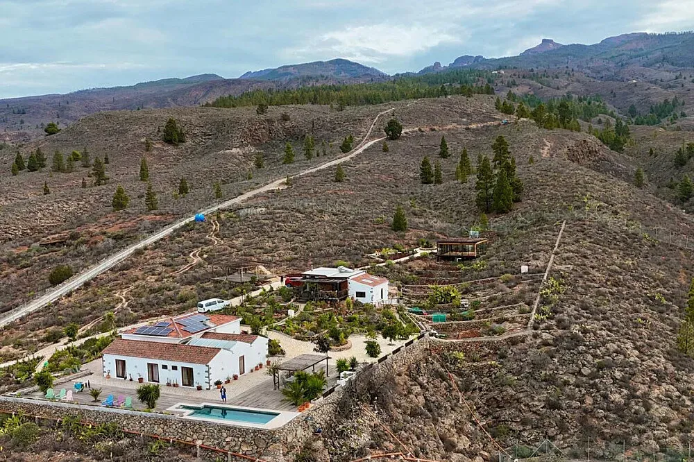 Casa del Cielo — This retreat is situated on a peaceful private finca, 1,050 meters above sea level in southern Tenerife. The property boasts sweeping 180-degree views of the Atlantic Ocean and surrounding mountains, with fruit trees, herbs, and flowers creating a lush, natural environment. A swimming pool and sun-drenched terraces are available for relaxation, while the garden yoga shala offers 360-degree views of the ocean, forest, and sky.