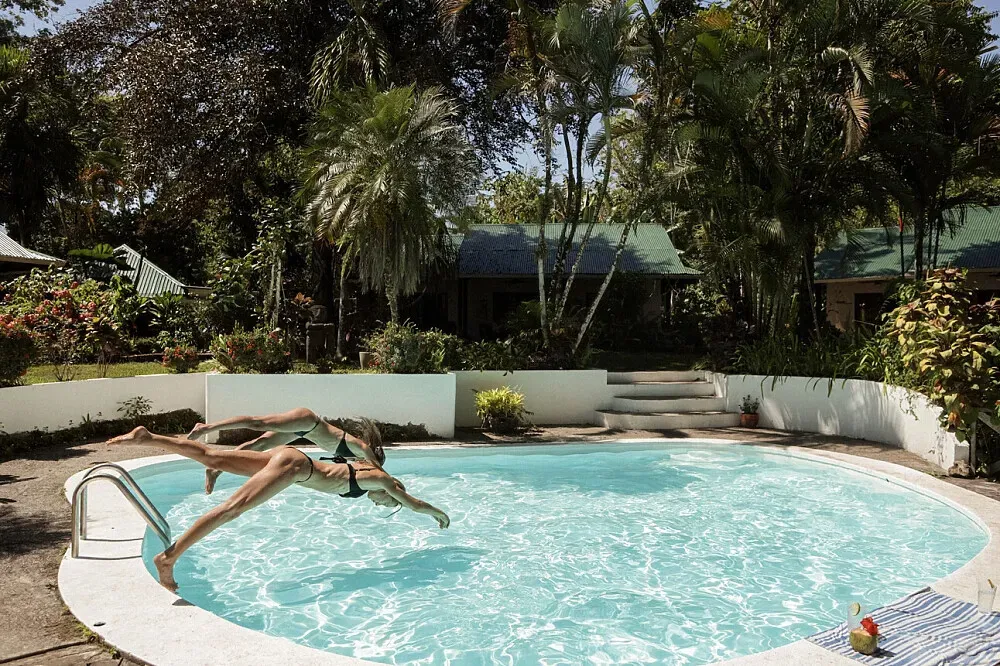 Casa Firefly — set on Costa Rica's Caribbean coast in Cahuita, Casa Firefly offers a lush, tropical environment. The air is warm and often humid, with the sounds of nature providing a constant backdrop. The proximity to the beach suggests a relaxed, coastal atmosphere.