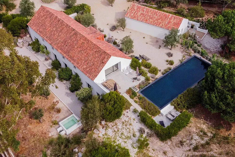 Casa Na Ferraria — Casa Na Ferraria is situated about half an hour south of Lisbon, enveloped by the natural fragrance of eucalyptus, pine, and cork oak trees. The setting provides a serene escape, allowing visitors to feel miles away from urban life despite its convenient proximity to the capital.