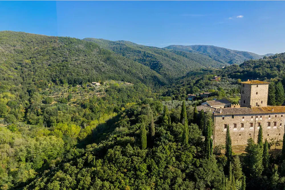 Castello di Mugnana — The retreat is situated within the impressive grounds of Castello di Mugnana, an ancient castle in the Metropolitan City of Florence. This historical backdrop provides a serene and contemplative atmosphere, far removed from the bustle of modern life. The surrounding Tuscan landscape likely offers scenic views and a sense of timeless beauty.