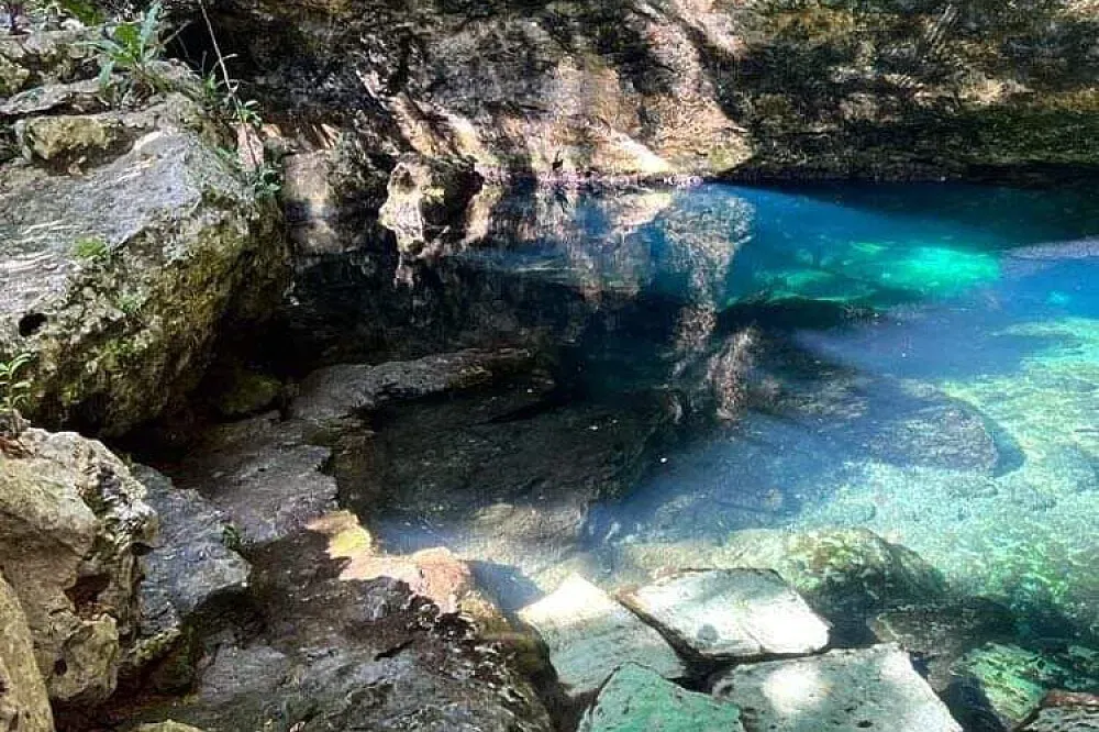 Cenote Balam-Ha — Located in the vibrant region of Tulum, Cenote Balam-Ha is characterized by its stunning natural cenote, a freshwater sinkhole surrounded by dense jungle. The atmosphere is one of natural wonder and quiet contemplation, far from the bustling tourist areas, offering a genuine connection to the local ecosystem.