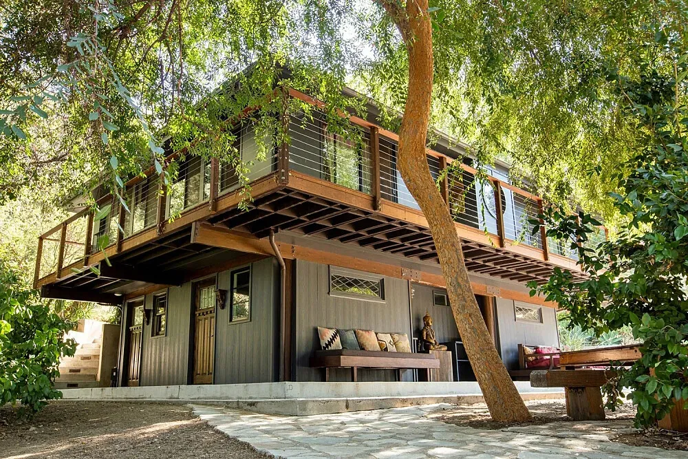Commune Topanga — At the very end of a winding road, Commune Topanga is set within a remote valley of the Santa Monica Mountains. The property spans ten acres, characterized by meandering paths that invite exploration and quiet contemplation amidst the natural landscape.