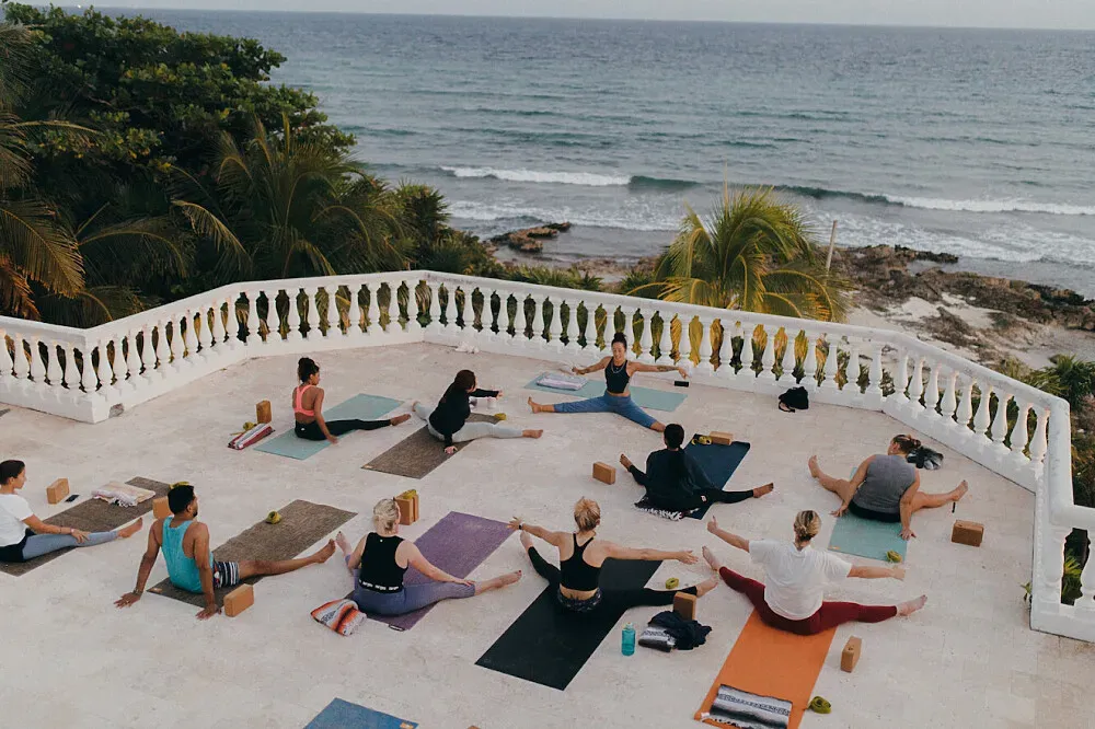 Copal Retreat Center — The center is situated directly on the ocean in Paamul, part of the vibrant Mexican Riviera Maya. The atmosphere is one of serene coastal beauty, with the sound of waves and panoramic Caribbean views creating a naturally calming environment. The rooftop studio space is a particular highlight, offering an elevated perspective of the sea and sky.