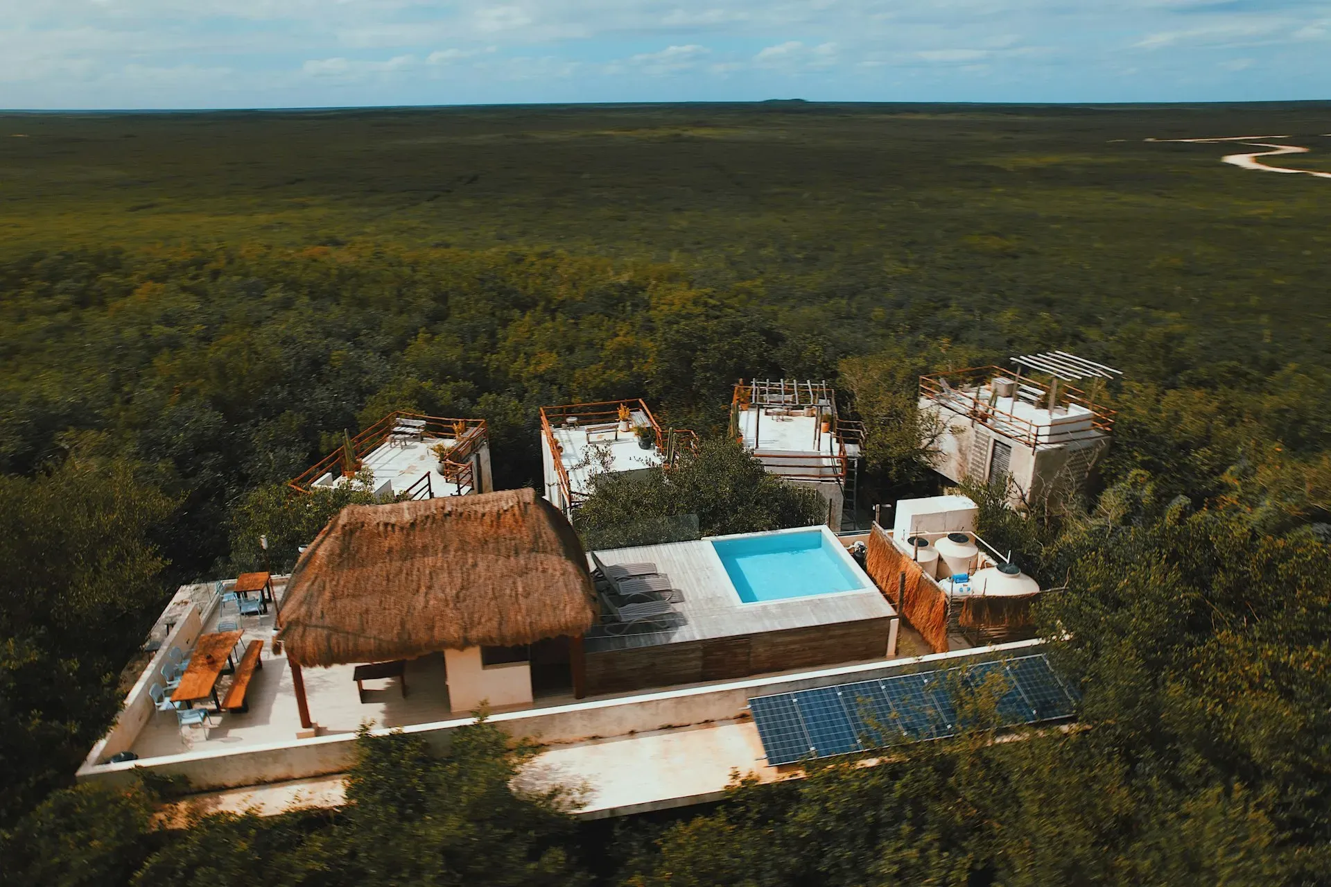 Dora Jungle — The center is situated in the lush jungle outside of Tulum, providing a secluded and natural environment. The atmosphere is one of tranquility and connection to the earth, with abundant greenery and natural water features creating a peaceful haven.