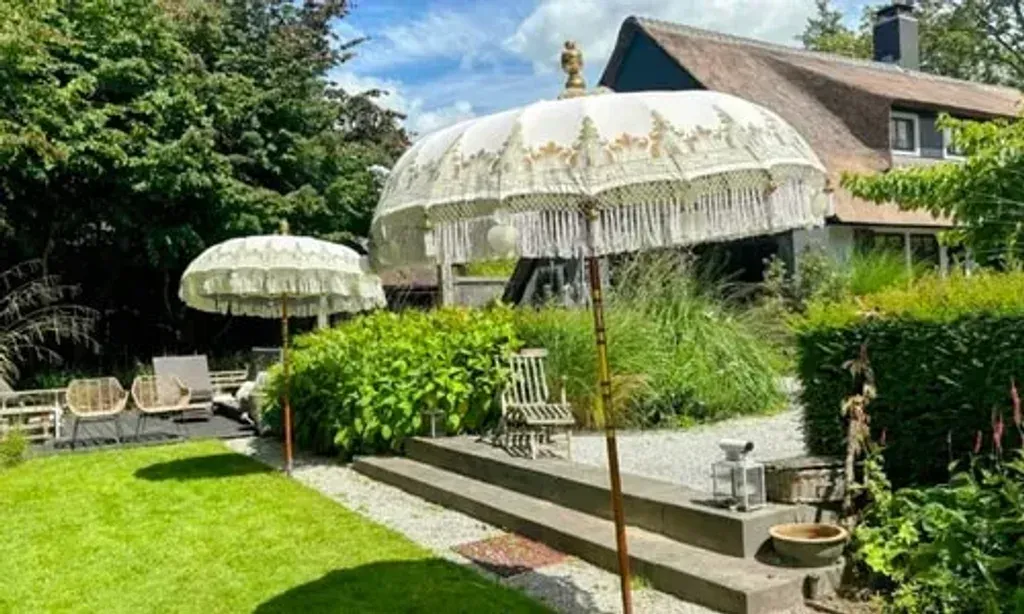 Elevated Mind Retreats — The retreat center is situated in a private, nature-immersed location, designed to encourage calm and presence. Expansive gardens, quiet corners for reflection, and a natural pond contribute to the serene atmosphere. During summer, ceremonies are held in a large bell tent, shaded by a 150-year-old tree, connecting participants deeply with the natural surroundings.