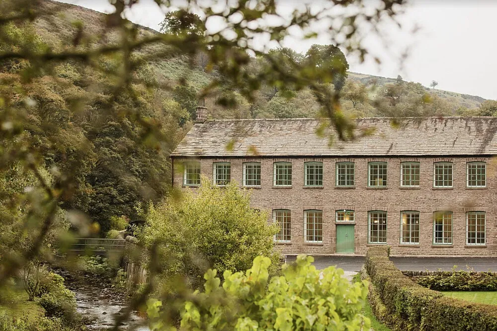 Gradbach Mill — The center is set against the stunning natural beauty of the Staffordshire Peak District, with the River Dane flowing gently alongside. The historic mill building itself contributes to a sense of timelessness and peace, creating an atmosphere conducive to quiet introspection and connection with the natural world.