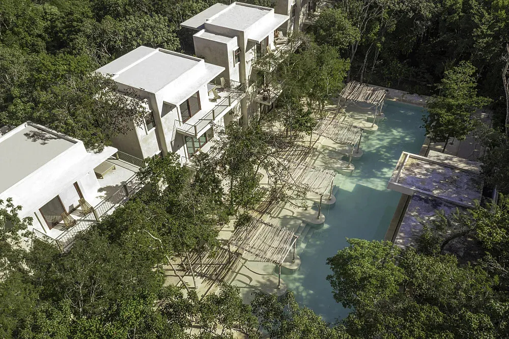 Holistika Tulum — Holistika Tulum is situated in the lively and naturally beautiful environment of Tulum, Mexico. The atmosphere is likely to be warm, inviting, and infused with the energetic spirit of the region, surrounded by tropical flora.