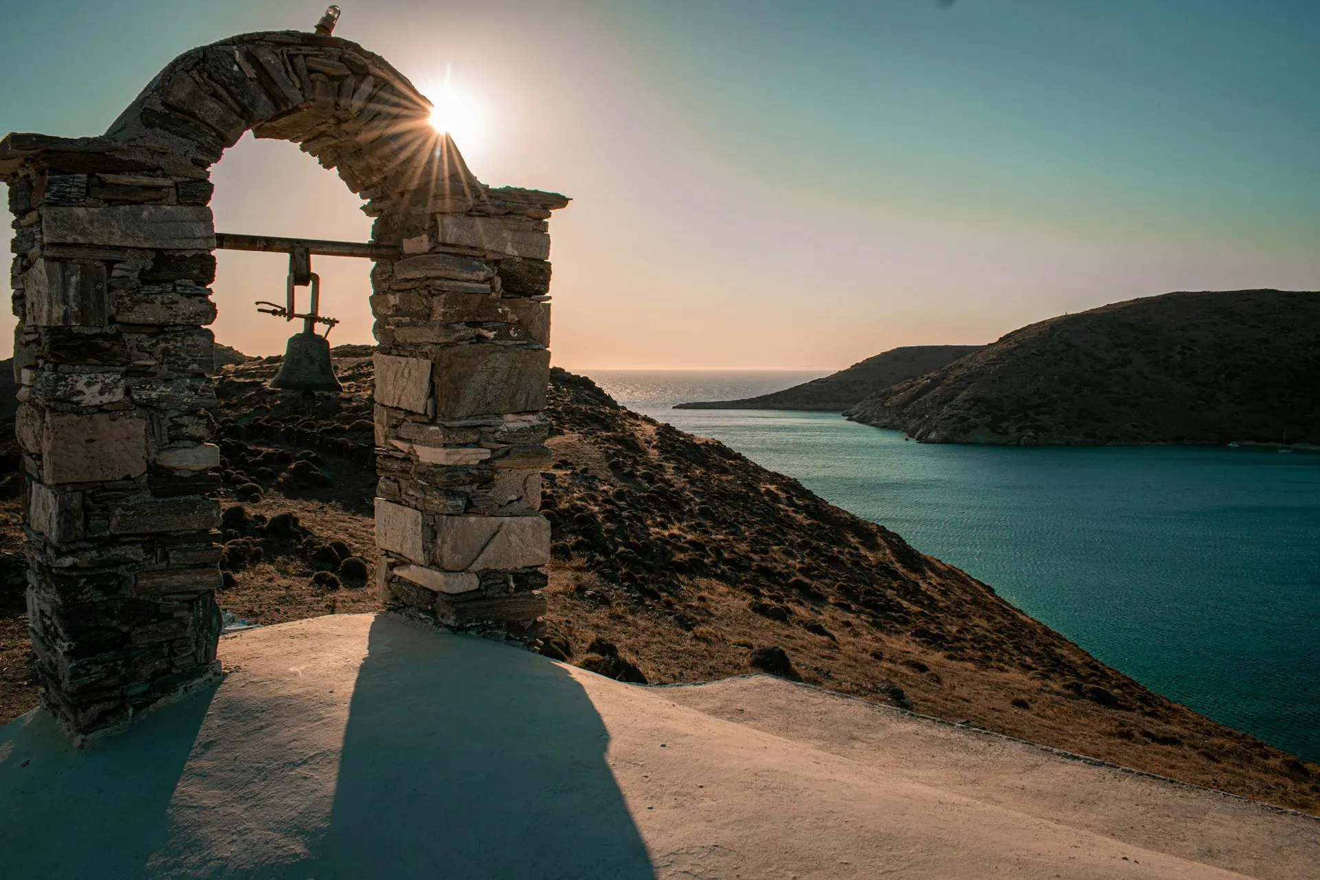 Ianemi Suites — The suites are situated on a scenic hillside on the island of Kythnos, offering expansive, breathtaking views of the Aegean Sea. The atmosphere is one of serene luxury, with the natural beauty of the island providing a tranquil backdrop to the opulent accommodations and inviting swimming pool.