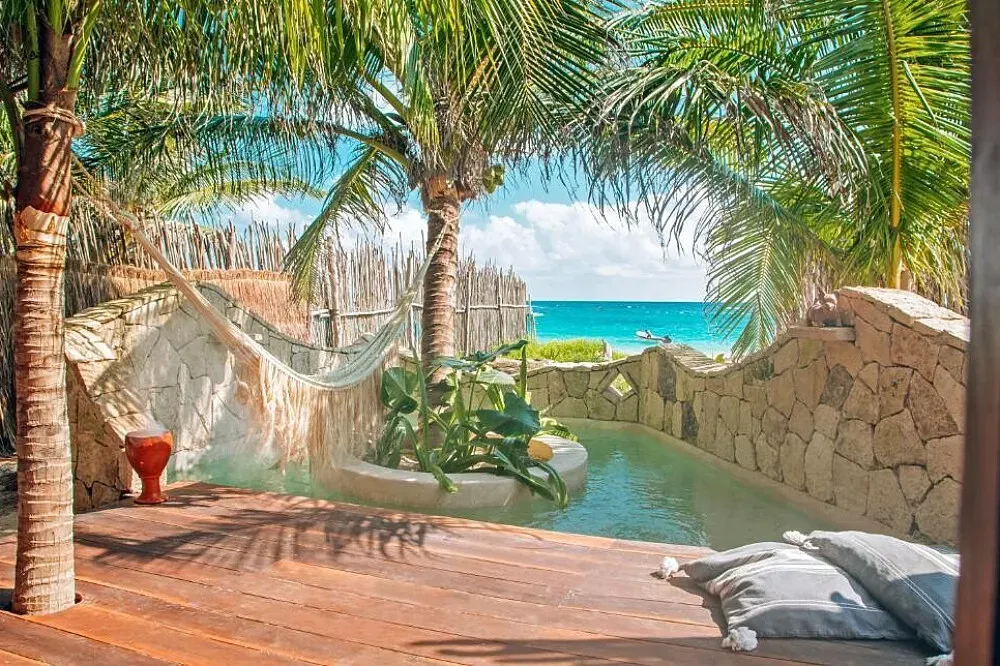 Ikal Tulum — Ikal Tulum is situated directly on the beautiful, sandy beaches of the Tulum hotel zone. The environment is characterized by its vibrant coastal energy, with the Caribbean Sea providing a constant backdrop of soothing sounds and refreshing breezes. The natural beauty of the area, combined with the center's unique atmosphere, creates a setting conducive to both relaxation and introspection.