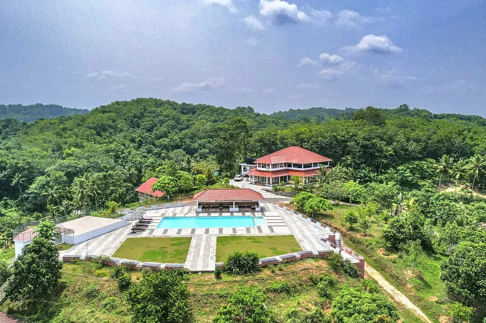Indimasi Healing Village — The center is situated amidst the lush, verdant landscapes of Kerala, providing a serene and natural environment. It operates as a living ecosystem, sustained by organic farms, which contributes to a deeply integrated healing experience.
