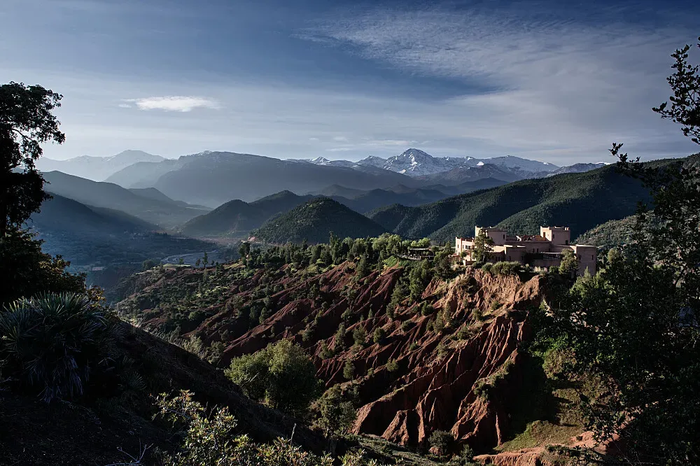 Kasbah Bab Ourika — Nestled within the Marrakesh-Safi region, Kasbah Bab Ourika is situated in a landscape that transitions from winding medinas to open desert. The atmosphere is one of profound beauty and ancient mysticism, with the grounding power of the land itself contributing to a sense of peace and inspiration.