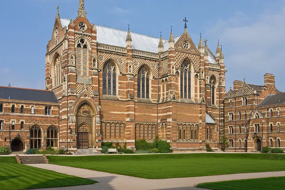 Keble College, University of Oxford — Keble College is situated within the bustling, historic city of Oxford. Its impressive Victorian Gothic architecture, with its distinctive red brick and intricate detailing, creates an atmosphere of academic prestige and quiet grandeur amidst the urban environment. The college grounds offer green spaces and courtyards, providing pockets of tranquility within the city.
