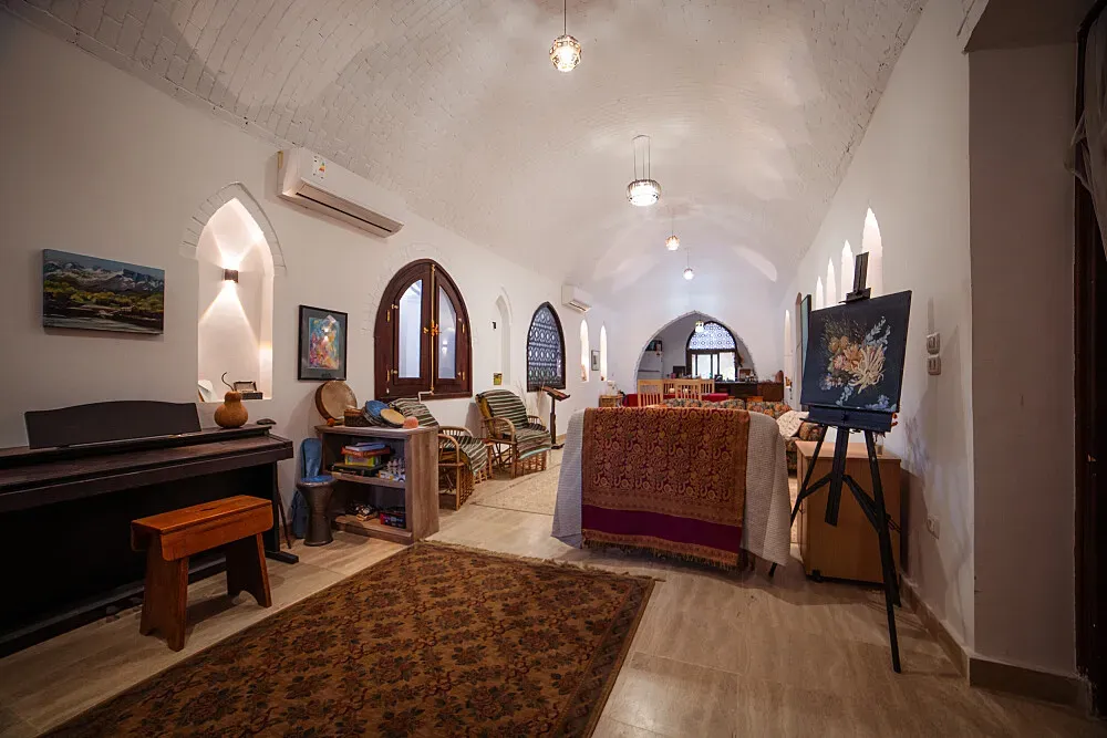 Malkata Arts Retreat — The retreat is located on the West Bank of Luxor, a region steeped in ancient history and natural beauty. It sits between the iconic Valley of Kings and the majestic Nile River, offering a serene and inspiring landscape. The architecture is described as soulfully built Nubian, suggesting a harmonious blend with the local environment and culture.