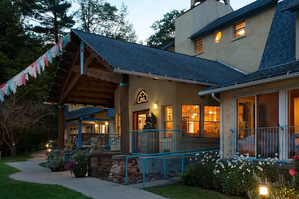 Menla Retreat & Dewa Spa — Menla is situated in a secluded valley within the Catskill Mountains, bordered by an enchanting stream. The center is enveloped by thousands of acres of untouched wilderness, providing a serene and natural atmosphere ideal for reflection and outdoor activities.