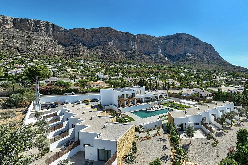 Mi Almazara Hotel — The hotel is situated in Jávea, described as the "jewel of the Mediterranean," a region rich with natural beauty and places to explore. The aesthetic emphasizes natural elements like stone, wood, and local flora, creating a harmonious and simple atmosphere.