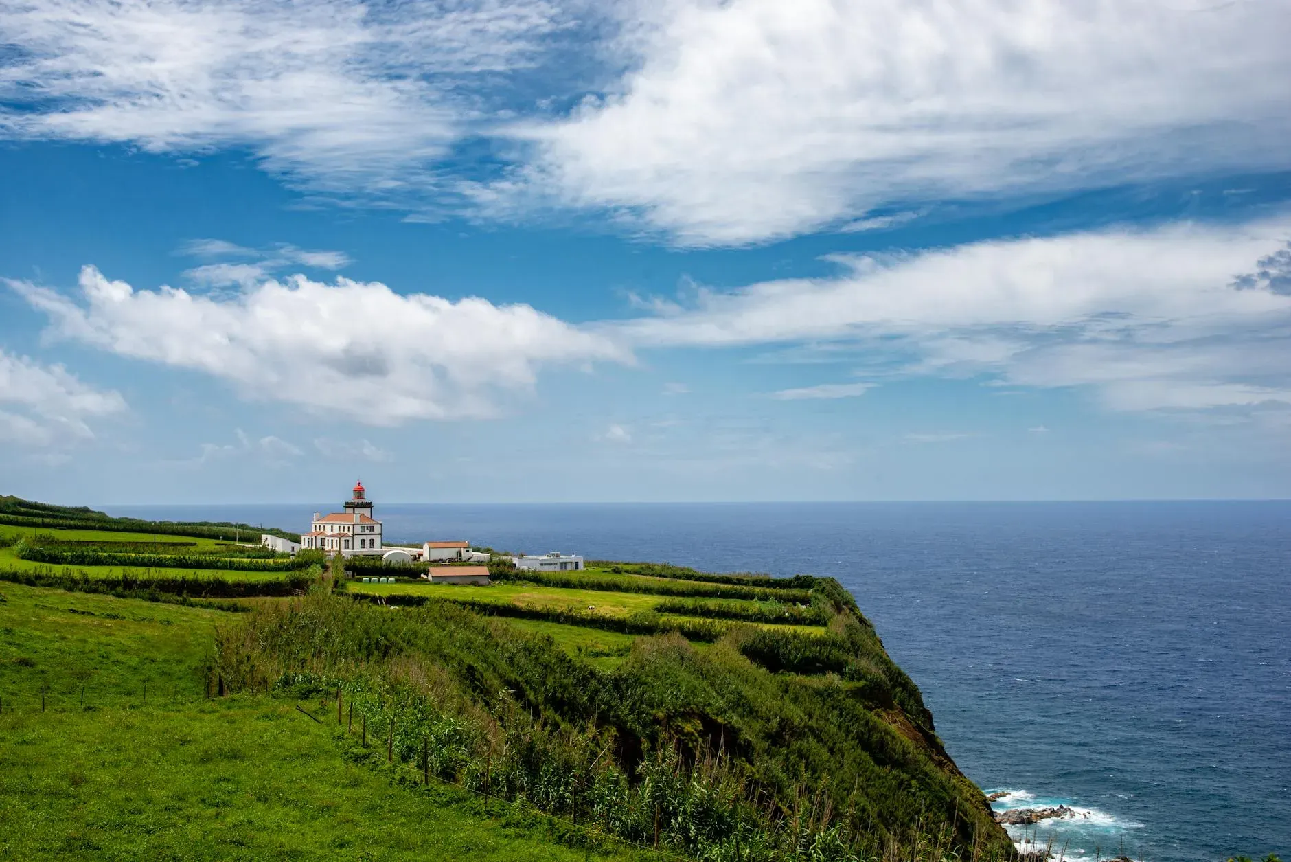 Minuvida — Minuvida is set within a traditional orchard on São Miguel Island, part of the Azores archipelago. The surroundings are characterized by lush, volcanic landscapes, offering a vibrant and abundant natural environment that encourages connection with the outdoors and a sense of tranquility.
