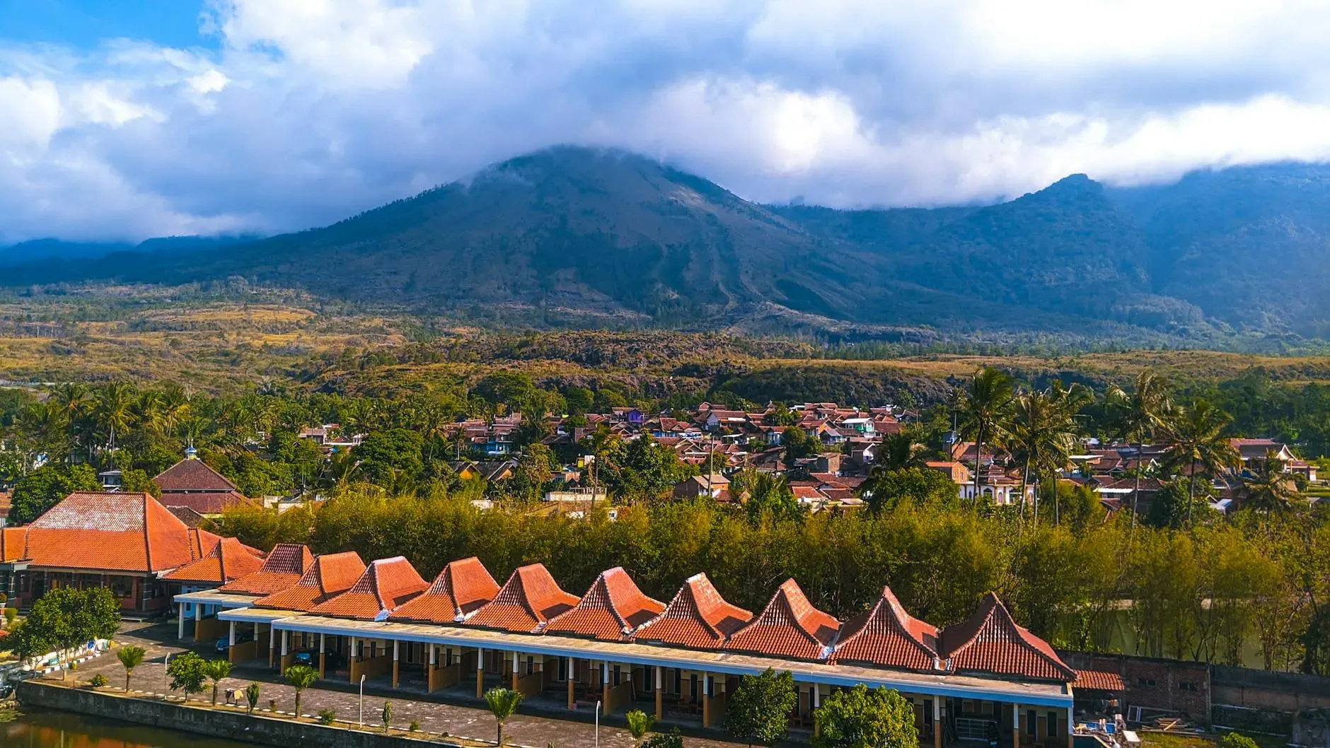 Nirarta Centre for Living Awareness — The center is situated in the peaceful Sideman hills of Bali, offering a truly idyllic landscape. Guests are surrounded by verdant valleys and meticulously sculpted rice terraces, with the awe-inspiring Mount Agung visible on the horizon, creating a backdrop of natural grandeur and tranquility.