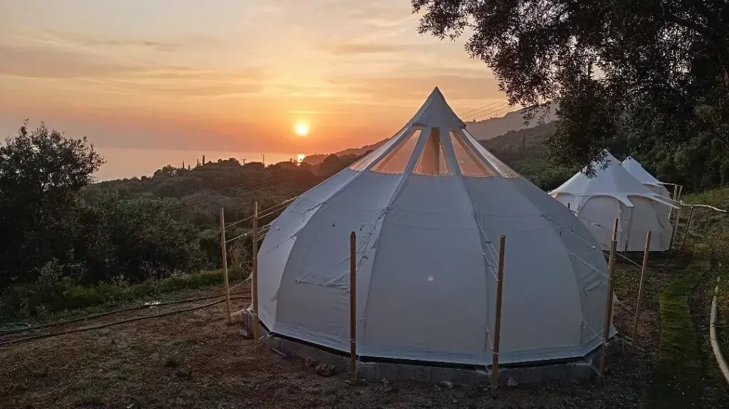 NtipZeN — Perched on the green hills of Kastrosikia, NtipZeN enjoys a picturesque location where ancient olive groves gently descend towards the quiet Lefka beach. The atmosphere is one of peaceful serenity, inviting guests to immerse themselves in nature's embrace.