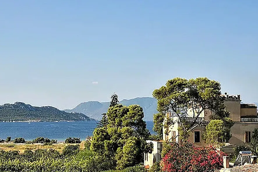 Oikia Karapanou — Located on Aegina, often called the "Pistachios Island," Oikia Karapanou is set within an enchanted garden. The atmosphere is described as simple, spacious, poetic, and refined, creating a deeply welcoming and unpretentious environment.
