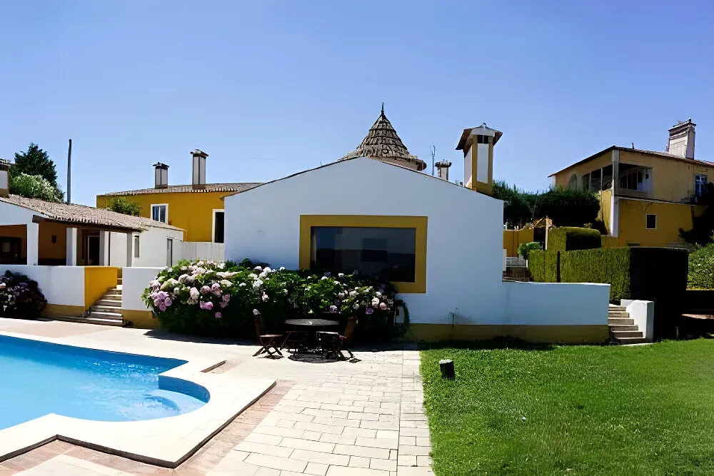 Quinta sao Jose dos Montes — The center is situated in a natural environment, emphasizing contact with nature as a core part of its offerings. The presence of organic vegetable gardens and an artesian well suggests a lush, self-sustaining landscape.