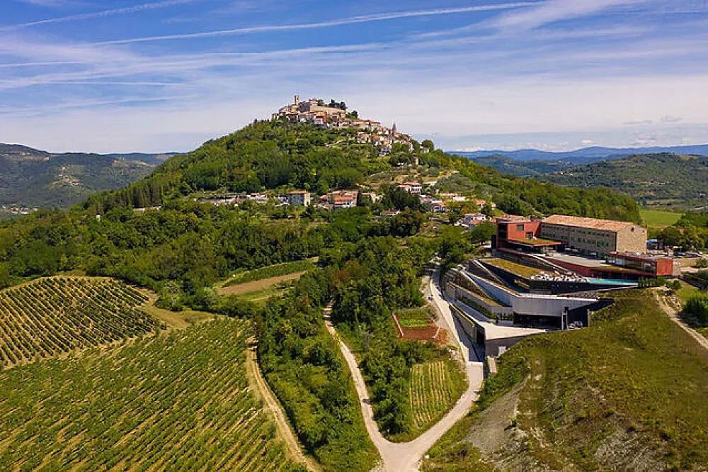 Roxanich Spa Hotel & Winery — Perched in the picturesque hilltop town of Motovun, the hotel is surrounded by sprawling vineyards, offering breathtaking panoramic views of the Istrian countryside. The atmosphere is one of serene luxury, blending the rustic charm of wine country with modern comforts and a focus on relaxation.