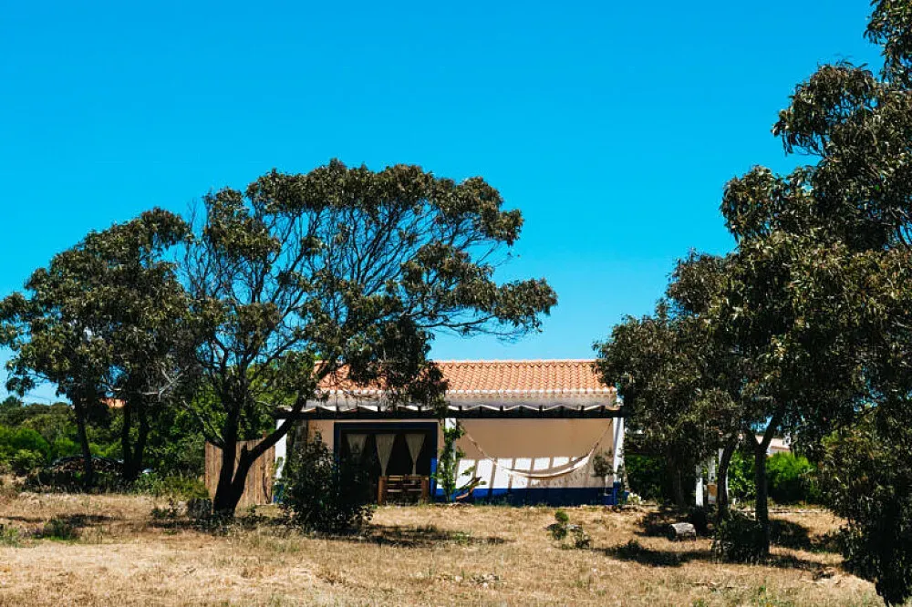 Soul Farm — The retreat is situated within the Southwest Alentejo and Costa Vicentina Natural Park, a region celebrated for being one of Europe's best-preserved coastlines. The 3-hectare property is rich in biodiversity, featuring cork trees, Acacias, and Eucalyptus, with the natural environment guiding the entire project's development.
