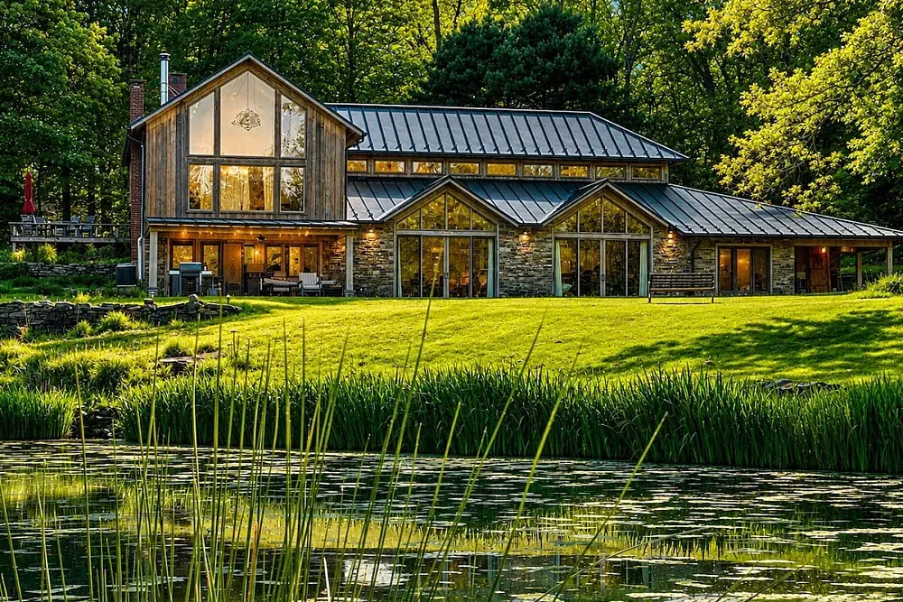Stunning  Modern Farmhouse Retreat — The retreat is set amidst the iconic red rock landscape of Sedona, offering a private sanctuary. The property itself boasts architect-designed features, with walls of glass framing views of two swimmable, spring-fed ponds, a natural waterfall, and serene, cultivated gardens. It's a harmonious blend of sophisticated design and untouched natural beauty, providing a deeply peaceful atmosphere.