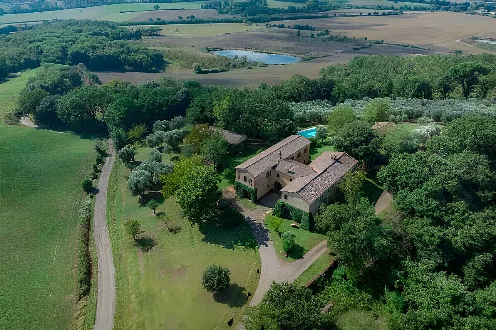 Tenuta Castelnuovo Tancredi — The estate spans 600 hectares of picturesque Tuscan landscape, featuring rolling hills, active vineyards, and ancient olive groves. It's situated next to the iconic Val d'Orcia, a UNESCO World Heritage site, and is conveniently located near the historic cities of Siena and Montalcino, offering a blend of natural beauty and cultural richness.