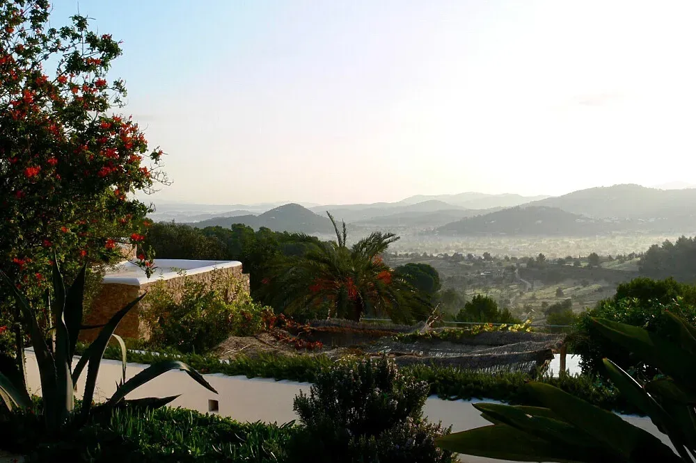 The Chettinad Retreat — Perched on a hillside in Ibiza, the retreat is set amidst verdant countryside, offering tranquil views. The property itself features a blend of traditional architecture with a centuries-old finca and modern, eco-conscious design elements.