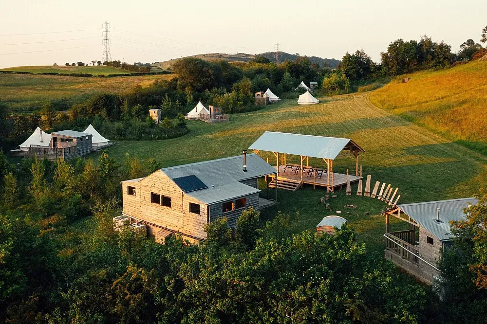 The Forge — The Forge is situated in the picturesque hills of North Wales, providing a serene and natural environment. The landscape is characterized by its green, undulating terrain, offering a sense of seclusion and immersion in the outdoors.