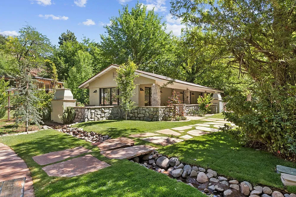 The Joy Sedona — The Joy Sedona is set within the breathtaking red rock landscape of Sedona, Arizona. The property spans over 50 acres, offering ample space for quiet contemplation and exploration. With private access to Oak Creek, the natural environment plays a significant role in the retreat experience, providing a tranquil and picturesque backdrop.