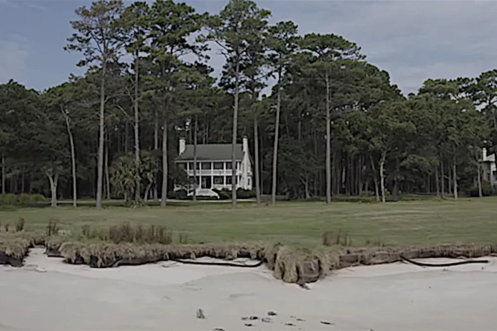 Twigg House, Daufuskie Island, SC — Perched on the historic Daufuskie Island, Twigg House boasts an enviable location with a fairway separating it from the Atlantic Ocean. The property offers expansive views of both the Calibogue Sound and the vast ocean, providing a constant backdrop of natural beauty. The atmosphere is one of serene coastal charm, where the sounds of the sea and the sight of local wildlife create a deeply calming environment.