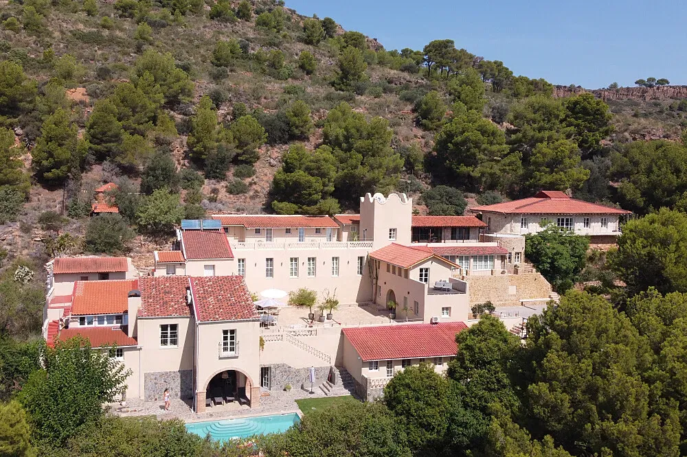 Villa Savi — The retreat is set in the Sierra Calderona mountains, offering sweeping views of the Mediterranean and pine-covered hills. The atmosphere is one of serene tranquility, with a blend of rustic charm and modern comfort creating a grounding and relaxing environment.