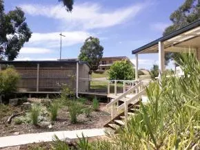 Dhamma Aloka — The center is situated on an eighteen-acre property in Woori Yallock, on a hill adjoining a reserve by the Yarra River. It offers expansive views across river flats to mountain ranges. The landscape is mostly cleared, fringed with ti-tree and eucalypt forest, creating an atmosphere of seclusion and tranquility.