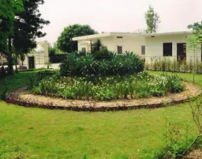 Dhamma Dhaja — The center is situated in the picturesque foothills of the Shivalik Mountains, providing a naturally peaceful and secluded environment conducive to meditation. The rural village setting of Anandgarh adds to the quietude, allowing practitioners to fully disengage from daily distractions and focus on their inner journey.