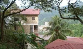 Penang — The center is situated on a hillside in Penang, providing pleasant views over the city of Georgetown. This temporary setup offers a focused environment for meditation, with the natural surroundings contributing to a sense of calm and detachment from urban life.