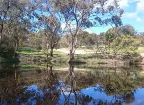 Dhamma Ujjala — The center is situated on a 23.6-hectare property in the Clare Valley, known for its pristine natural beauty. The land is characterized by hilly terrain, offering expansive views to the west, and is dotted with gum trees and grassy areas. Its secluded location, just 3 km from the Clare township, ensures a quiet and peaceful atmosphere, enhanced by the presence of local wildlife and two small dams.