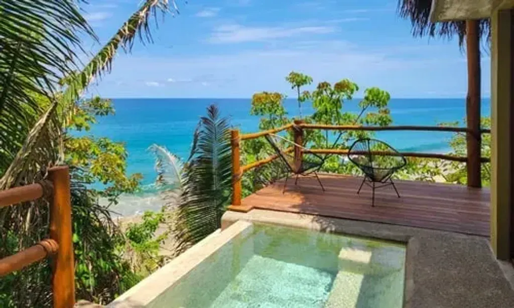 Afuera Getaway — Afuera Getaway is situated in a private cove, enveloped by over 300 acres of vibrant jungle. This secluded oasis offers a peaceful escape, yet remains conveniently close to the lively beach towns of Sayulita and San Pancho. The oceanfront location provides a stunning backdrop for relaxation and connecting with the natural beauty of the Riviera Nayarit.