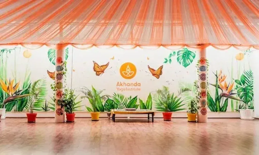 Akhanda Anand Prakash Yoga Retreats — Located on Badrinath Road in Tapovan, Rishikesh, the center is immersed in the spiritual heartland of India. While specific landscape details are not provided, its location near the SBI bank suggests an accessible yet potentially vibrant area within Rishikesh, known for its Ganges River views and surrounding Himalayan foothills. The mention of 'Himalayan rhythms' hints at a connection to the natural environment.