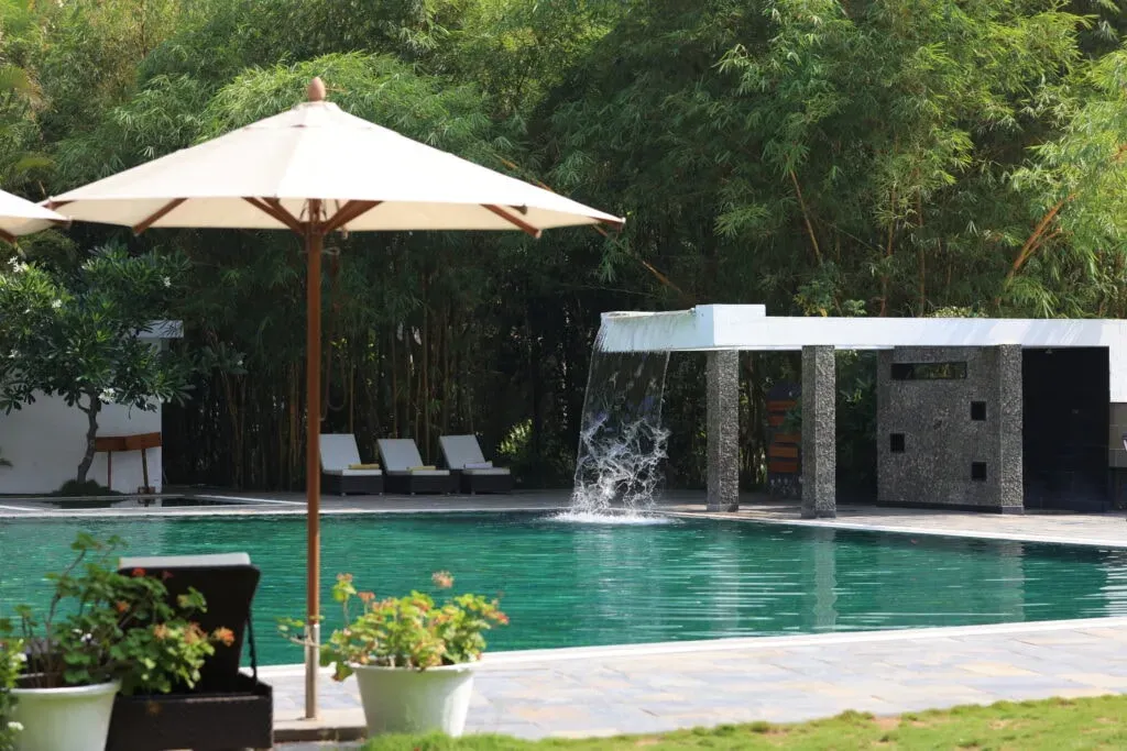 Amanvana Spa Resort — Nestled along the River Kaveri in the lush landscapes of Coorg, the resort provides a tranquil environment. The natural beauty of the area, with its serene river and verdant surroundings, creates an ideal atmosphere for unwinding and enjoying the outdoors.