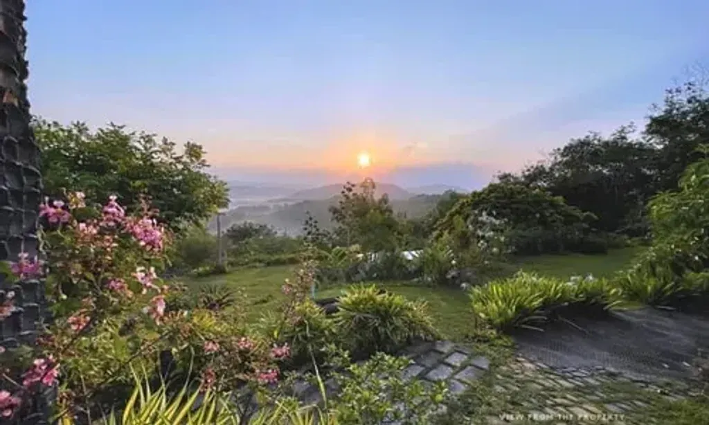Antharyamin — Nestled near the Sahyadri mountain range in Trivandrum, Antharyamin boasts breathtaking sunrise views. The rugged outlines of the Sahyadri Hills emerge against a sky painted with soft shades of pink, lavender, and orange as dawn breaks. The resort is enveloped by a tropical climate, with year-round temperatures between 24-28°C, and is enriched with naturally grown Ayurvedic plants, trees, and fruits, creating a peaceful and verdant sanctuary.