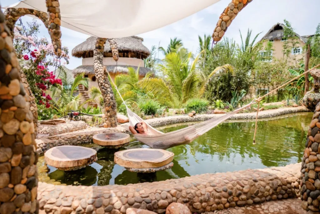 Barbarenas — Barbarenas is situated on a hilltop in Colonia Brisas de Zicatela, offering expansive ocean vistas. The property is enveloped by a lush tropical garden, creating a serene and natural atmosphere that complements the laid-back, surf-centric vibe of Puerto Escondido.
