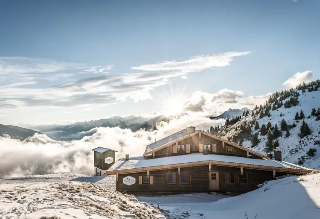 Berggasthaus & Lodge Resterhöhe — Perched amidst the vast landscapes of the Kitzbüheler Alpen, the lodge is surrounded by dramatic mountain scenery and offers breathtaking views. The atmosphere is one of serene natural beauty, where the raw power of the mountains meets thoughtful, modern design, creating a tranquil and inspiring environment.