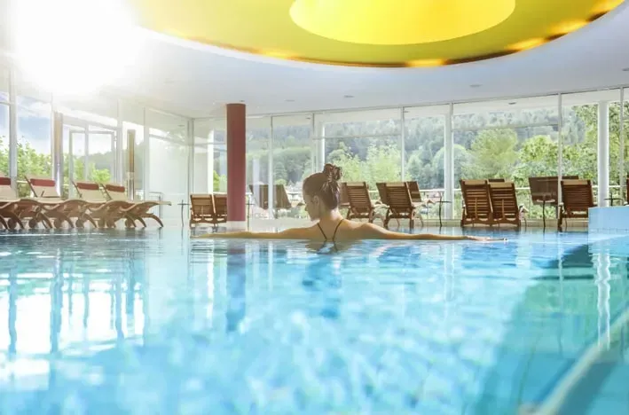 Building Roots — The retreat unfolds in the picturesque spa town of Bad Herrenalb, set within Germany's Black Forest. The Schwarzwald Panorama Hotel provides a serene backdrop with expansive views, modern seminar rooms bathed in natural light, and direct access to nature trails. The atmosphere is one of peaceful reflection, supported by the hotel's commitment to ecological standards.