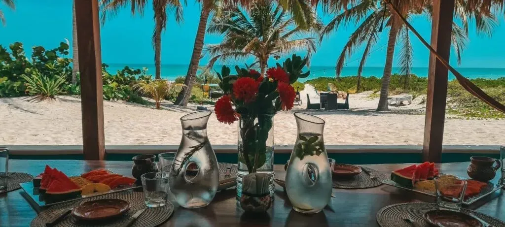 Casa Awakening — Casa Awakening is situated directly on the white sands of El Cuyo, a tranquil fishing village in Yucatan. The villa offers stunning views of the emerald and turquoise Gulf of Mexico, providing a serene backdrop for relaxation. The village itself is known for its laid-back atmosphere and is conveniently located just a short walk from local restaurants and the town center.